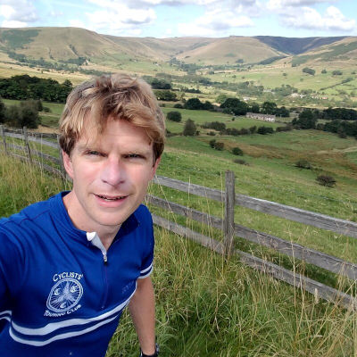 James in blue CTC jersey with green valley behind